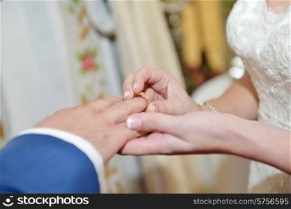 Hands of groom and bride, wedding ring close up