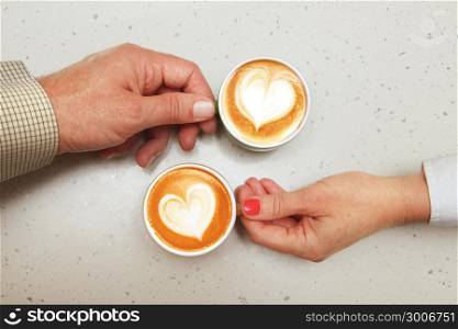 hands of lovers which hold cups of coffee