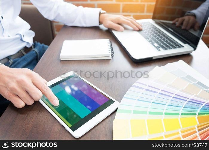 Hands of male hipster modern graphic designer in office working with colour samples. man at workplace choosing colour swatches, closeup. Creative people concept