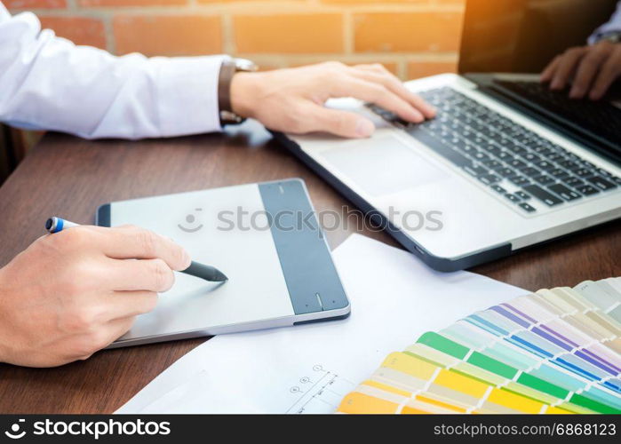 Hands of male hipster modern graphic designer in office working with colour samples. man at workplace choosing colour swatches, closeup. Creative people concept