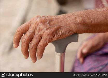 hands of old woman asia with a cane walking stick