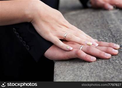 hands of the bride and groom with the rings