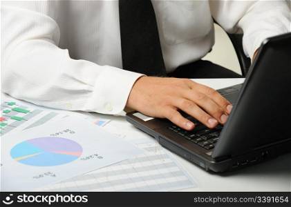 Hands of the businessman above the keyboard laptop