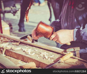 hands of the craftsman carve a bas-relief with a gouge. Craftsman hands working. Work Of Artist