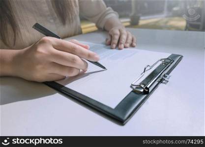 Hands of Woman Completing Application Form