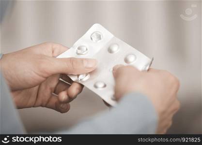 Hands of woman holding pack of medicament