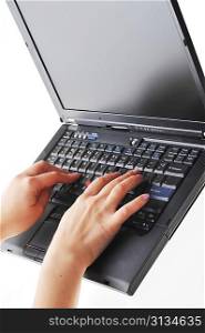 hands of woman typing on laptop keyboard
