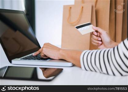 Hands of woman using a credit card for online shopping.