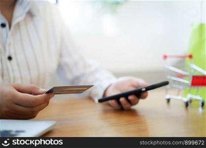 Hands of woman using a credit card for online shopping.