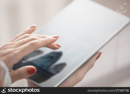 Hands of woman using digital tablet