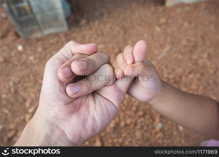 hands of young child and adult