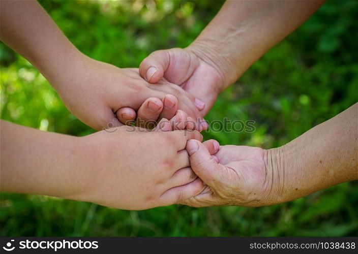 hands of young child and old senior