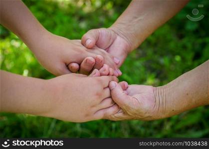 hands of young child and old senior