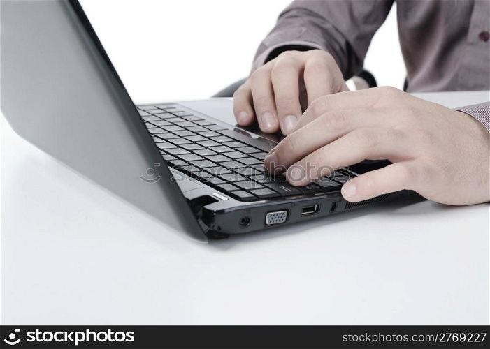 Hands on the laptop keyboard. Isolated on white background