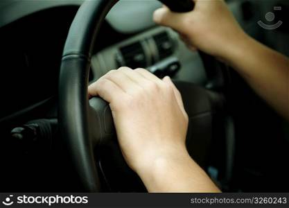 hands on the wheel, selective focus on nearest part