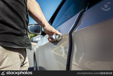 Hands opening the car door. Close-up of male hand opening car door. Vehicle owner opening the door with the keys. car rental concept