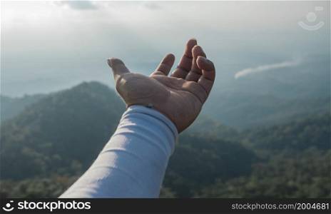 Hands outstretched to receive natural light and mountain views
