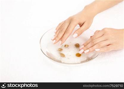 Hands take the salt bath, isolated on a white background
