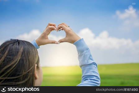 Hands together in a heart shape, woman’s hands together in a heart shape, hands making a heart shape
