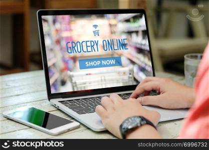 Hands typing laptop computer with grocery shopping online on screen background, business and technology, lifestyle concept