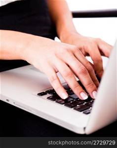 Hands typing on laptop Indoor studio
