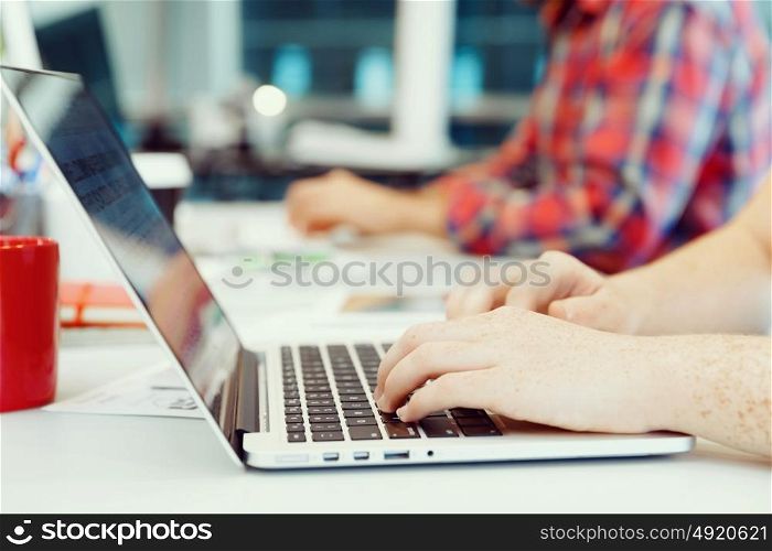 Hands typing on the keyboard. Hands of office worker typing on the keyboard