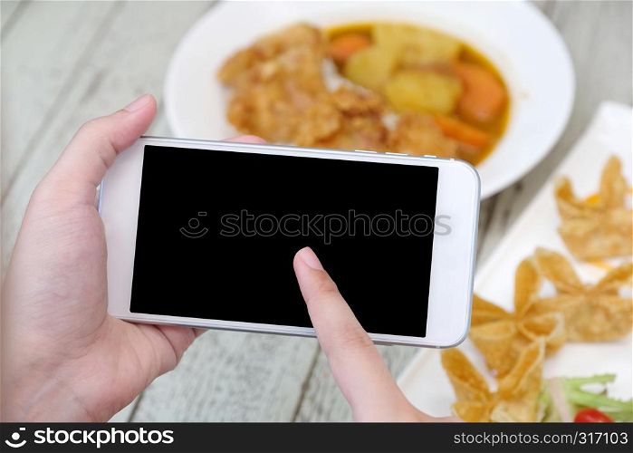 Hands using smart phone with blank screen over blur food background, mock up, template, food online and delivery concept