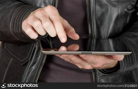 hands with black tablet computer