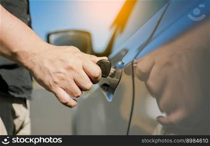 Hands with keys opening the car door. Close-up of hands opening the car door with the key. Vehicle owner opening the door with the keys.