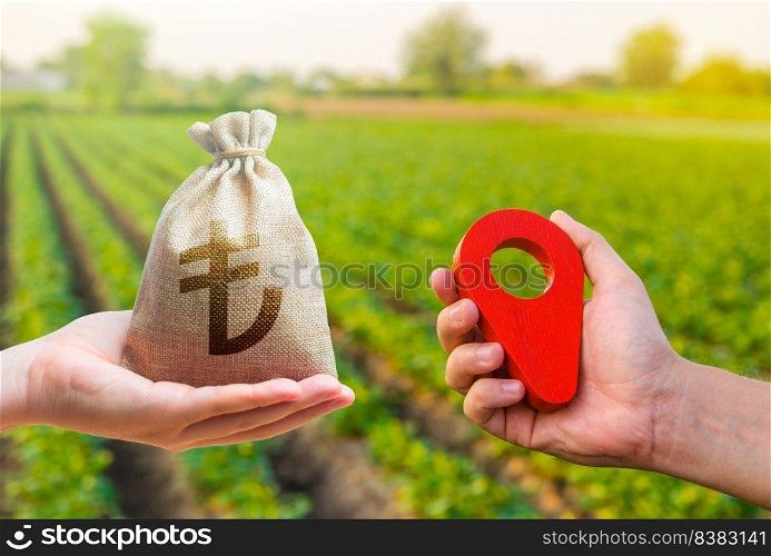 Hands with location pin and turkish lira money bag. Land market. Estimation cost of plots. Transport and construction industry. Buying and selling land. Agriculture agribusiness.