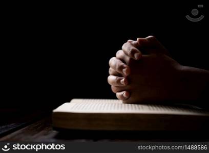 hands woman laying on the biblical while praying for christian religion blessings and Pray to God