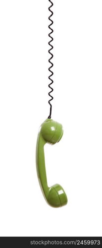 Handset piece from an old phone suspended by the phone cord, isolated on white background