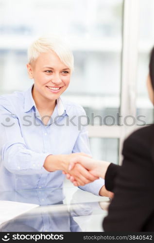 Handshake between businesswomen in the office