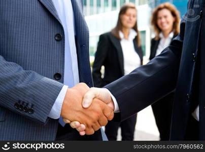 Handshake in front of business people