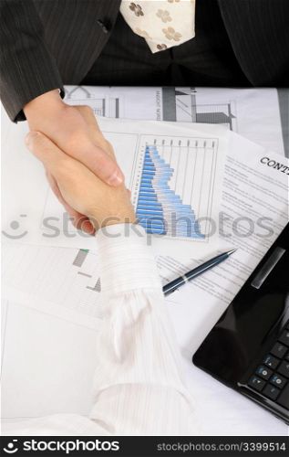 Handshake of business partners, when signing contract.