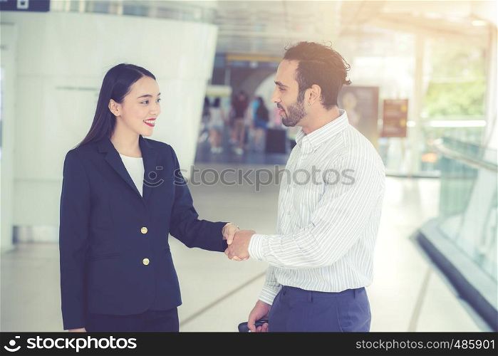 Handshake of businessman and businesswoman of business meeting, Partnership with agreement dealing of customer, discussion of team together with success.