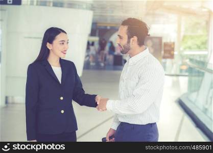Handshake of businessman and businesswoman of business meeting, Partnership with agreement dealing of customer, discussion of team together with success.