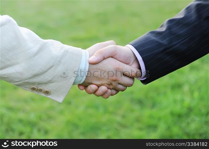 Handshake of two men in black and white suits