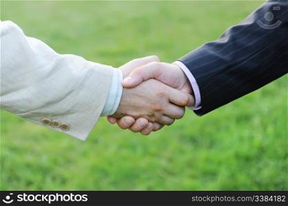 Handshake of two men in black and white suits