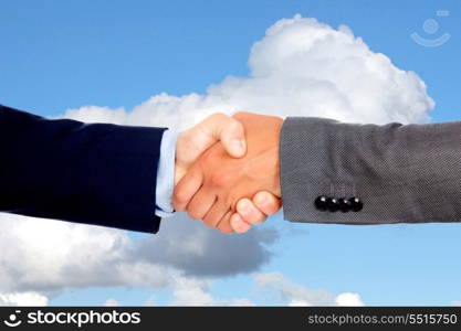Handshake with businessmen on a blue sky with clouds of background