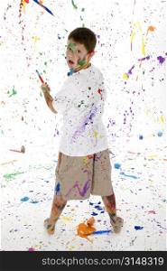 Handsome 8 year old boy caught making mess with paints.