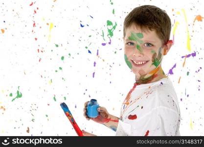 Handsome 8 year old boy painting.