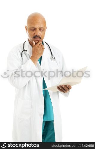 Handsome african-american doctor reviewing a patient&rsquo;s medical chart. Isolated on white.