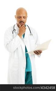 Handsome african-american doctor reviewing a patient&rsquo;s medical chart. Isolated on white.