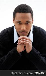 Handsome African American male in blue shirt and black sweater, isolated