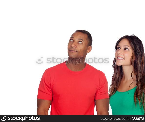 Handsome african guy and his caucasian girl looking up isolated on a white background