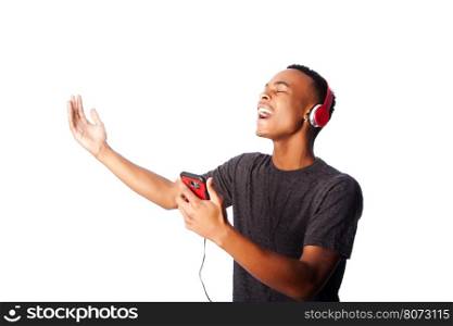 Handsome African teenager happily singing along while listening to music, on white.