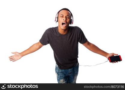 Handsome African teenager happily singing along while listening to music, on white.