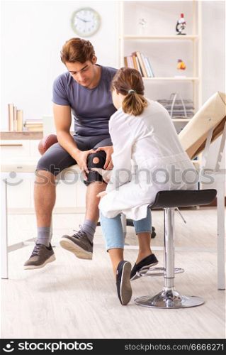 Handsome american footbal player visiting female doctor traumatologist . Handsome american footbal player visiting female doctor traumato