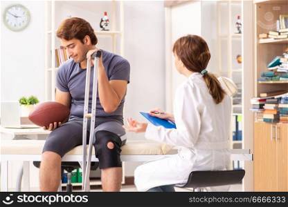 Handsome american footbal player visiting female doctor traumatologist . Handsome american footbal player visiting female doctor traumato